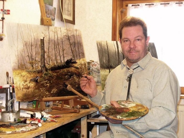 Maler mit Landschaftsbild und Palette.